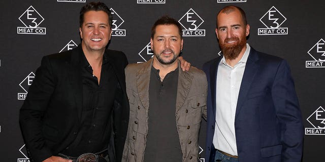 Luke Bryan (at left), Jason Aldean (center), and Adam LaRoche attend the grand opening of E3 Chophouse Nashville on Nov. 20, 2019 in Nashville, Tennessee. Bryan and LaRoche appeared on "Fox and Friends Weekend" on Sunday to discuss their efforts to help America's veterans through the E3 Ranch Foundation. 