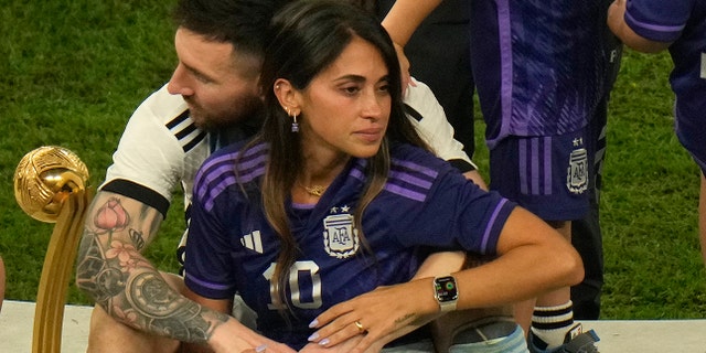 Lionel Messi sits with his wife Antonela Roccuzzo after Argentina won the World Cup in Lusail, Qatar, Sunday, Dec. 18, 2022.