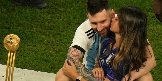 Antonela Roccuzzo kisses Lionel Messi after Argentina won the World Cup, Sunday, Dec. 18, 2022.