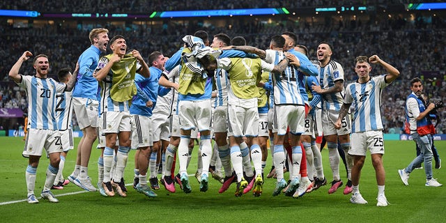 Argentina's players celebrate after their win in a penalty shootout during a FIFA World Cup Qatar 2022 quarterfinal match against the Netherlands at Lusail Stadium Dec. 9, 2022, in Lusail City, Qatar.