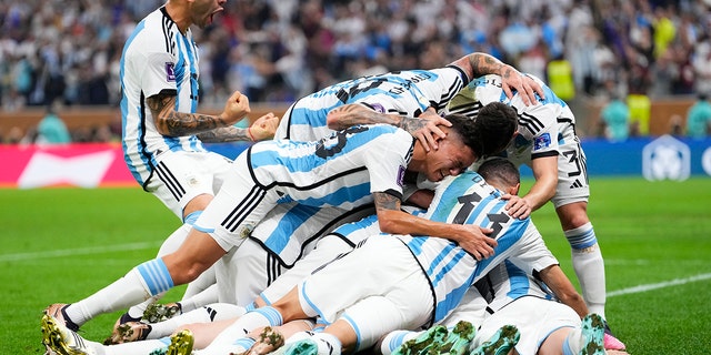 Argentina's players celebrate after Lionel Messi scored his side's opening goal against France in Lusail, Qatar, Sunday, Dec.18, 2022.
