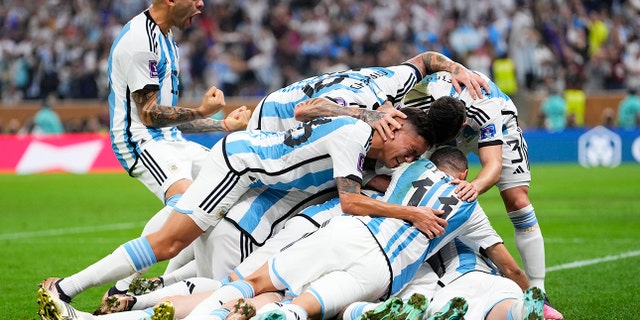 Argentina's players celebrate after Lionel Messi scored his side's opening goal against France in Lusail, Qatar, Sunday, Dec.18, 2022.