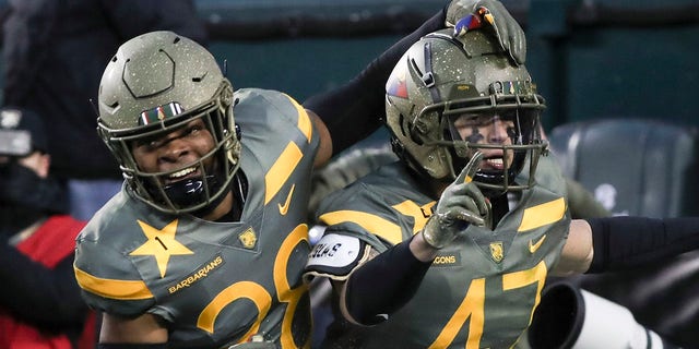 Army defensive back Noah Short (47) celebrates blocking a punt by Navy punter Riley Riethman for a touchdown in the second quarter of a game in Philadelphia Saturday, Dec. 10, 2022. At left is defensive back Donavon Platt.
