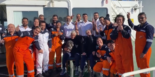 The crew from the Hong Kong-flagged tanker, Silver Muna, recovers two men and their dog that were aboard a sailboat that had been adrift for several days in the Atlantic Ocean, Dec. 13 2022. 