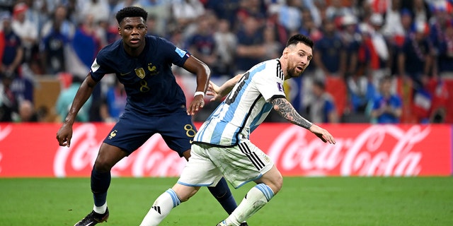 Lionel Messi of Argentina competes for the ball with Aurelien Tchouameni of France during the World Cup final match at Lusail Stadium on Dec. 18, 2022, in Lusail City, Qatar.