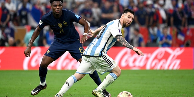 Lionel Messi of Argentina competes for the ball with Aurelien Tchouameni of France during the World Cup final match at Lusail Stadium on Dec. 18, 2022, in Lusail City, Qatar.