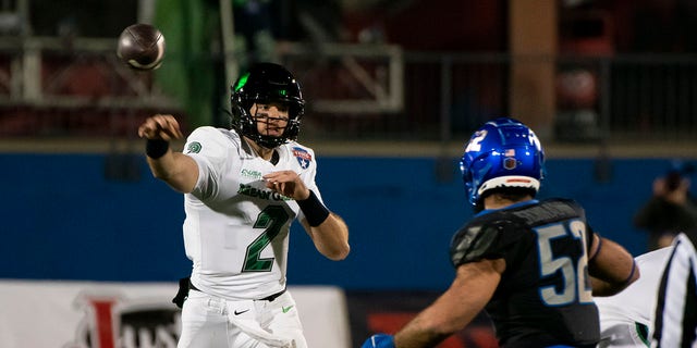 Quarterback Austin Aune (2) of the North Texas Mean Green throws a pass in the first half as linebacker DJ Schramm (52) of the Boise State Broncos defends at Toyota Stadium Dec. 17, 2022, in Frisco, Texas.