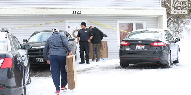 The belongings of the victims of the University of Idaho quadruple homicide are removed from the house in Moscow, Idaho, Wednesday, December 7, 2022.