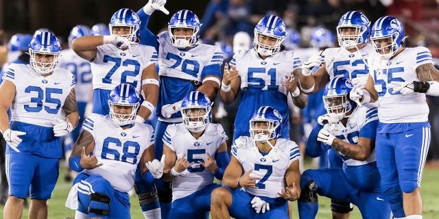 PALO ALTO, CA - NOVEMBER 26: The BYU Cougars football team, including Houston Heimuli #35, Sione Veikoso #72, Kingsley Suamataia #78, Alden Tofa #51, Joe Tukuafu #52, Lorenzo Fauatea #55, Peter Falaniko #68 and others, pose for a group photo prior to an NCAA college football game against the Stanford Cardinal on November 26, 2022, at Stanford Stadium in Palo Alto, California. 