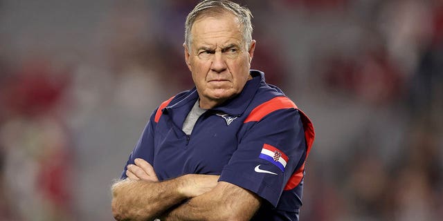 New England Patriots head coach Bill Belichick looks on before a game against the Arizona Cardinals at State Farm Stadium on December 12, 2022 in Glendale, Arizona.
