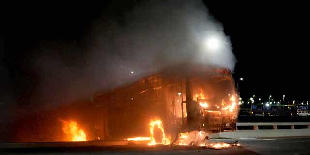 Supporters of Brazilian President Jair Bolsonaro set fire to vehicles and allegedly tried to storm the headquarters of the Federal Police in Brasilia, Brazil, on Dec. 12, 2022. 