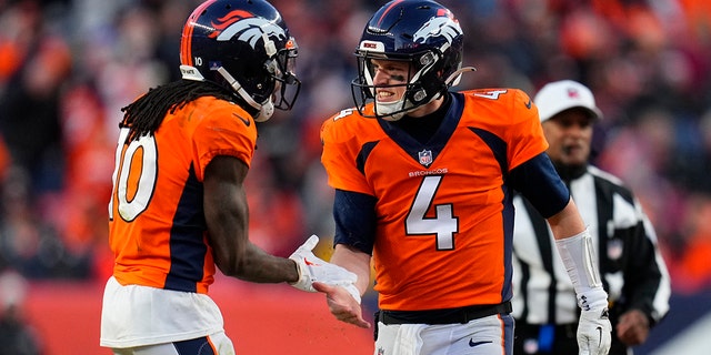 Denver Broncos quarterback Brett Rypien (4) celebrates with wide receiver Jerry Jeudy (10) during the second half of an NFL football game against the Arizona Cardinals, Sunday, Dec. 18, 2022, in Denver. 