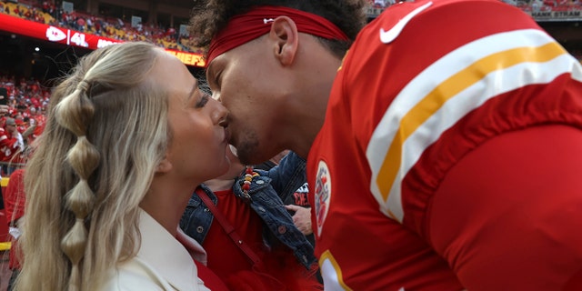 Patrick Mahomes of the Kansas City Chiefs kisses wife Brittany before a game against the Los Angeles Chargers at Arrowhead Stadium Sept. 15, 2022, in Kansas City, Mo.