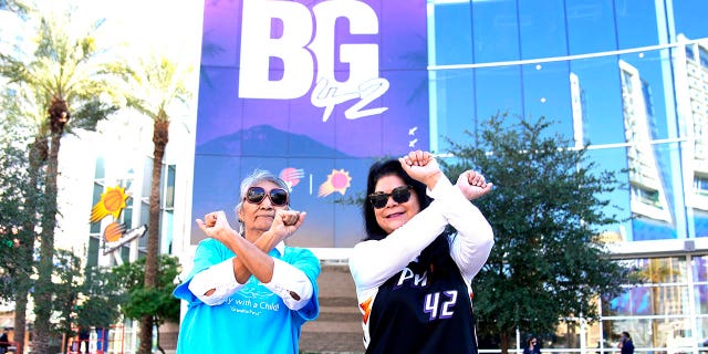 Perci Ami, left, of Laveen, Ariz., and Patty Talahongva show support for Brittney Griner, Thursday, Dec. 8, 2022, in Phoenix. Griner was released from a Russian prison in a prisoner swap earlier in the day.