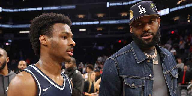 Bronny James with his father, LeBron James, after a Sierra Canyon Trailblazers game in Phoenix on December 11, 2021.