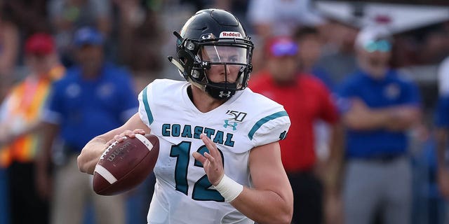 Coastal Carolina Chanticleers quarterback Bryce Carpenter (12) looks to throw as he rolls out in the second quarter of an FBS football game between the Coastal Carolina Chanticleers and Kansas Jayhawks on September 7, 2019 at Memorial Stadium in Lawrence, KS.
