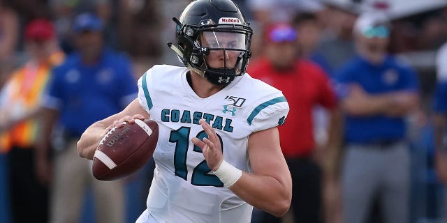 Coastal Carolina Chanticleers quarterback Bryce Carpenter (12) looks to throw as he rolls out in the second quarter of an FBS football game between the Coastal Carolina Chanticleers and Kansas Jayhawks on September 7, 2019 at Memorial Stadium in Lawrence, KS.