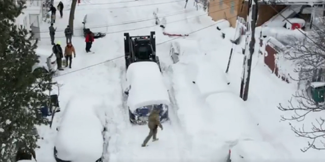 The Rook is used to move cars blocking snowy streets in Buffalo, New York.