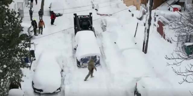 The Rook is used to move cars blocking snowy streets in Buffalo, New York.