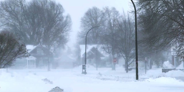 The high wind blows the snow across a neighborhood in Buffalo, N.Y., on Saturday, Dec. 24, 2022.