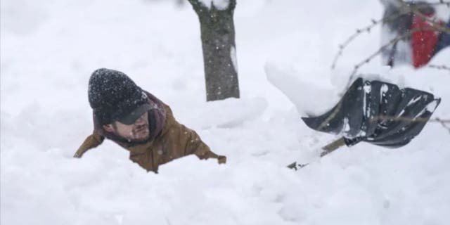 Tommy Roetzer digs out his driveway on West Delavan Street in Buffalo, N.Y., on Monday, Dec. 26, 2022.