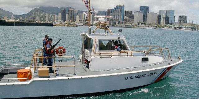 HONOLULU, HI - JUNE 13: A U.S. Coast Guard boat patrols Honolulu Harbor June 13, 2002.
