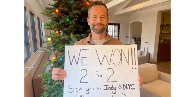 Kirk Cameron, former "Growing Pains" star, holds a hand-drawn poster in a December 2022 photo.