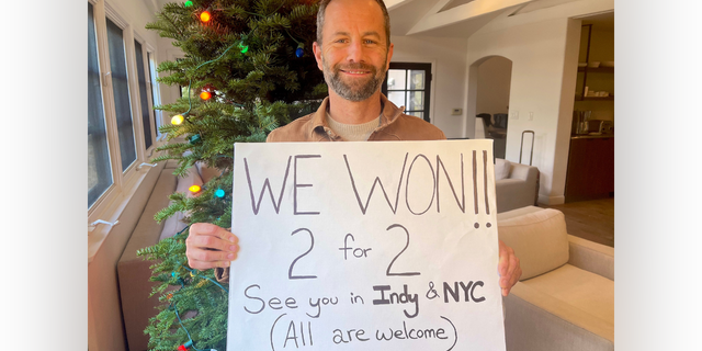 Kirk Cameron, former "Growing Pains" star, holds a hand-drawn poster in a December 2022 photo.