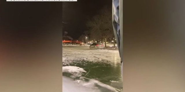 Video captures a car driving on frozen canal in downtown Indianapolis.