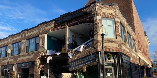 A sedan crashed into the front of a building in a residential neighborhood in Boston on Sunday morning, taking out almost half of the facade.