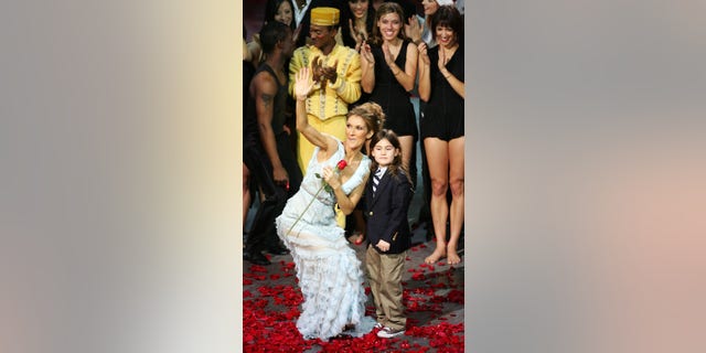 Celine Dion stands with her son at the final performance of her Caesar's show.