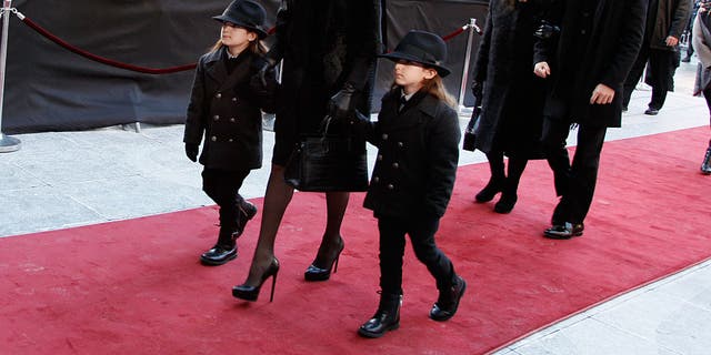 Celine Dion, with children Nelson Angélil, Rene-Charles Angélil, Eddy Angélil and mother Therese Dion, attend her husband's funeral.