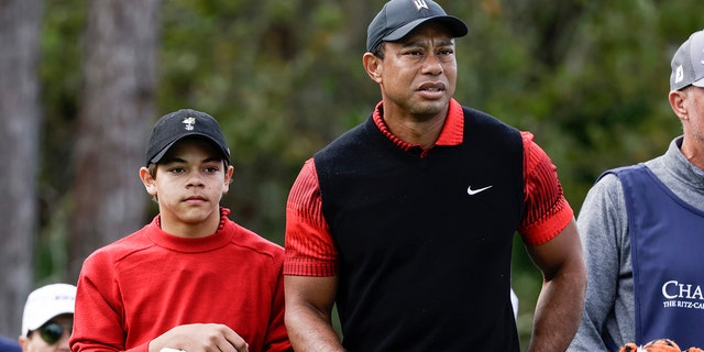 Tiger Woods and his son, Charlie, prepare to tee off on the third hole during the final round of the PNC Championship golf tournament in Orlando, Florida, on Dec. 18, 2022.