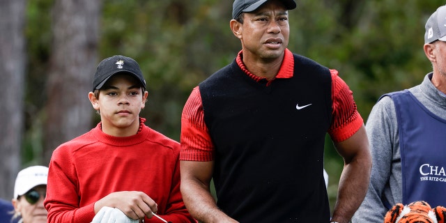 Tiger Woods and his son, Charlie, prepare to tee off on the third hole during the final round of the PNC Championship golf tournament in Orlando, Florida, on Dec. 18, 2022.
