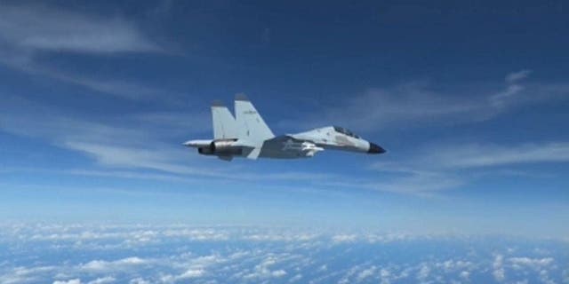 Footage of a Chinese pilot piloting a jet just 10 feet from a US Airforce RC-135 aircraft on December 21. (Credit: Ministry of Defence)