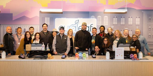 Chris Long poses with Curaleaf employees at the company's Bordentown, N.J., location Dec. 7, 2022.