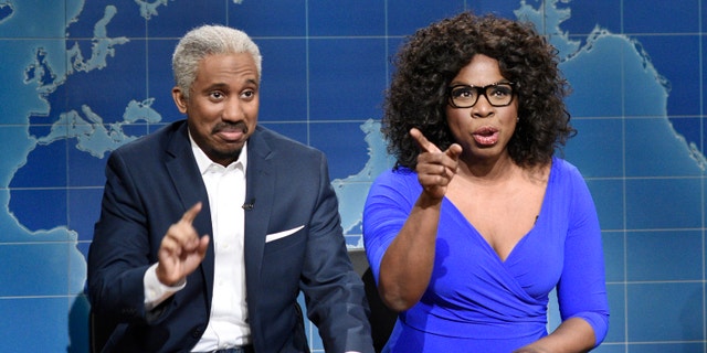 Chris Redd as Stedman Graham, and Leslie Jones as Oprah Winfrey, during "Weekend Update" on "Saturday Night Live."