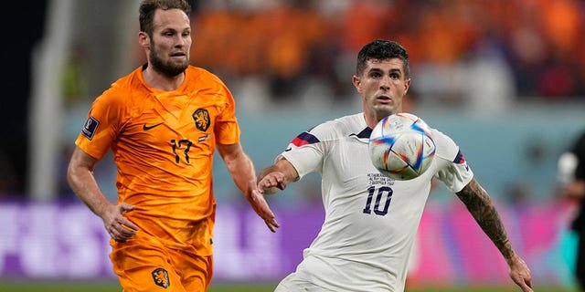 Christian Pulisic of the United States, right, goes for the ball Daley Blind of the Netherlands follows him during the World Cup round of 16 soccer match between the Netherlands and the United States, at the Khalifa International Stadium in Doha, Qatar, Saturday, Dec. 3, 2022. 