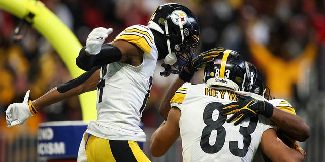 Pittsburgh Steelers tight end Connor Heyward (83), wide receiver George Pickens (14) and running back Najee Harris celebrate a touchdown against the Atlanta Falcons in the second quarter at Mercedes-Benz Stadium, Dec. 4, 2022, in Atlanta.