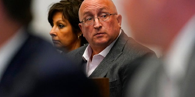 Robert E. Crimo III's father Robert Crimo Jr., right, and mother Denise Pesina attend to a hearing for their son in Lake County court on Aug. 3, 2022, in Waukegan, Ill. Prosecutors announced Friday that Crimo Jr., the father of the Illinois man charged with killing seven people in a mass shooting at a July 4 parade in a Chicago suburb, has been charged with seven felony counts of reckless conduct.