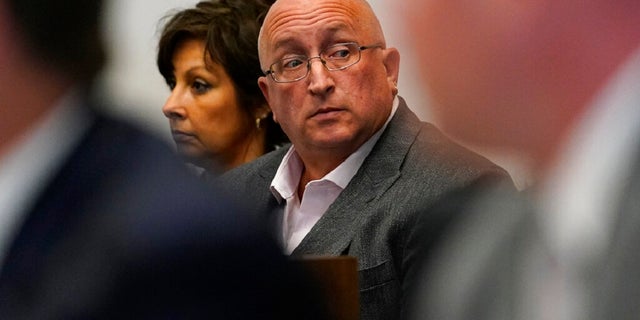 Robert E. Crimo III's father Robert Crimo Jr., right, and mother Denise Pesina attend to a hearing for their son in Lake County court on Aug. 3, 2022, in Waukegan, Ill. Prosecutors announced Friday that Crimo Jr., the father of the Illinois man charged with killing seven people in a mass shooting at a July 4 parade in a Chicago suburb, has been charged with seven felony counts of reckless conduct. 