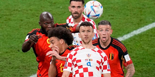 Croatia's Ivan Perisic, front, goes up for the ball against Belgium players during the World Cup group F match at the Ahmad Bin Ali Stadium in Al Rayyan, Qatar, Thursday, Dec. 1, 2022.