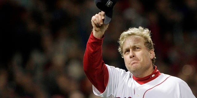 Red Sox pitcher Curt Schilling tips his cap to fans as he is taken out of the World Series against the Colorado Rockies in Boston on Oct. 25, 2007.