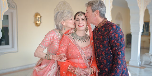 Rogers' parents are shown wishing their daughter well as she wears her traditional Indian wedding attire.