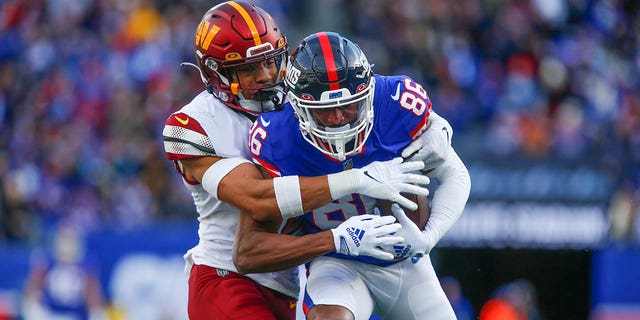New York Giants' Darius Slayton, right, makes a catch during the first half against the Washington Commanders, Dec. 4, 2022, in East Rutherford, New Jersey.