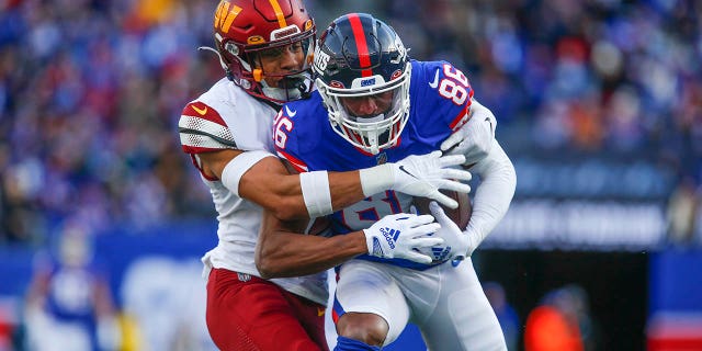 New York Giants' Darius Slayton, right, makes a catch during the first half against the Washington Commanders, Dec. 4, 2022, in East Rutherford, New Jersey.