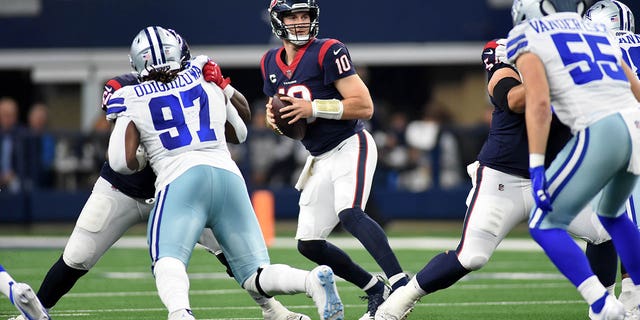 Houston QB Davis Mills looks for an open man against the Dallas Cowboys on Dec, 11, 2022, at AT and T Stadium in Arlington, Texas.