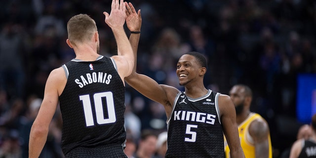 Sacramento Kings guard De'Aaron Fox, #5, and forward Domantas Sabonis, #10, celebrate during the second half of the team's NBA basketball game against the Los Angeles Lakers in Sacramento, California, Wednesday, Dec. 21, 2022. 