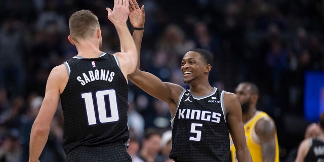 Sacramento Kings guard De'Aaron Fox, #5, and forward Domantas Sabonis, #10, celebrate during the second half of the team's NBA basketball game against the Los Angeles Lakers in Sacramento, California, Wednesday, Dec. 21, 2022. 