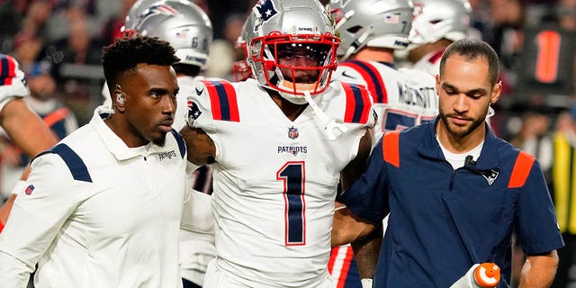 New England Patriots wide receiver DeVante Parker, #1, is carried off the field after a play against the Arizona Cardinals during the first half of an NFL football game, Monday, Dec. 12, 2022, in Glendale, Arizona.